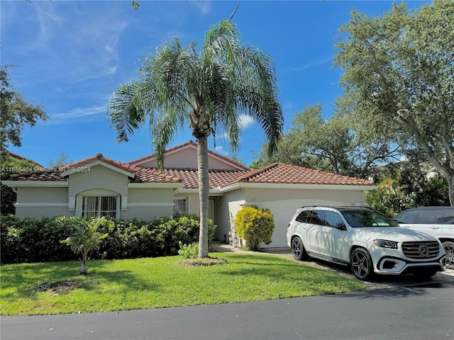 mediterranean / spanish-style house featuring a front yard