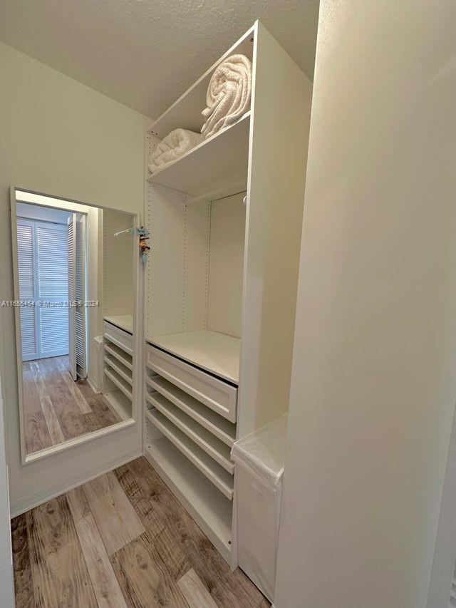 walk in closet featuring light hardwood / wood-style floors