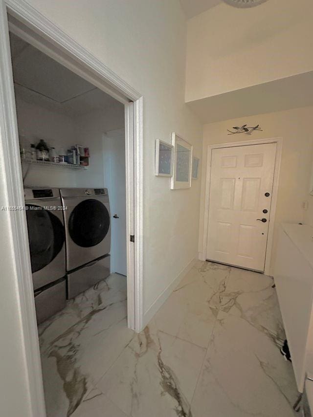 laundry area featuring washing machine and clothes dryer