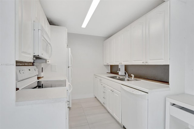 kitchen with sink, light tile patterned flooring, white appliances, and white cabinetry