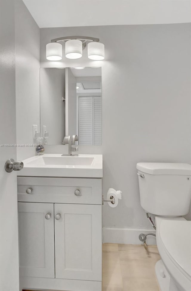 bathroom featuring vanity, toilet, and tile patterned flooring