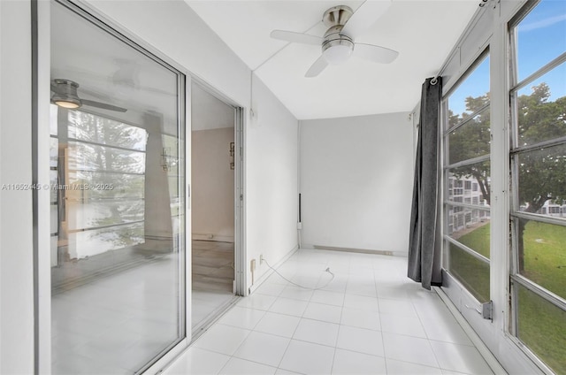 unfurnished sunroom featuring ceiling fan