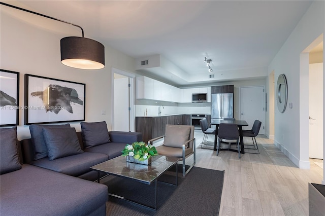 living room featuring light hardwood / wood-style floors and sink