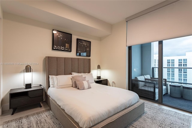 bedroom featuring wood-type flooring and floor to ceiling windows