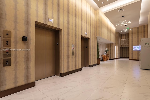 corridor with high vaulted ceiling and elevator