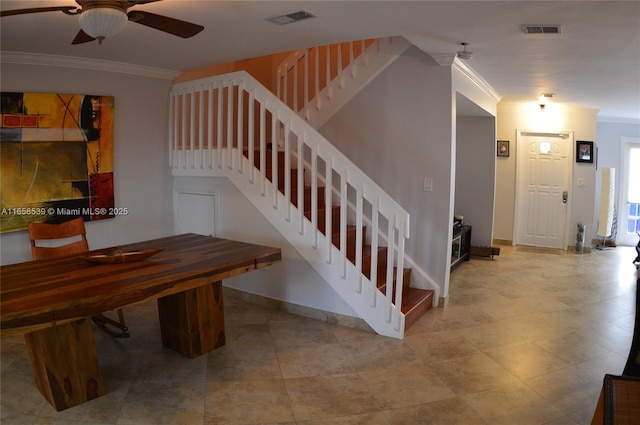 staircase with ceiling fan and ornamental molding