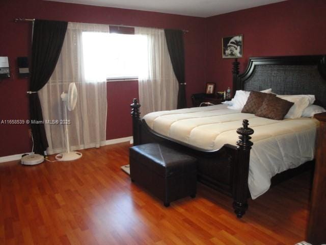 bedroom with wood-type flooring