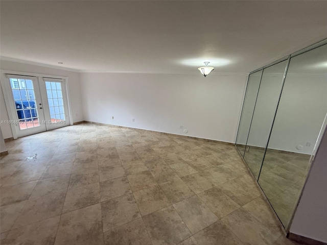 unfurnished bedroom featuring access to exterior, french doors, ornamental molding, and a closet