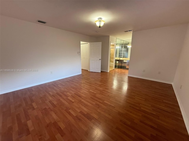 spare room featuring dark hardwood / wood-style flooring