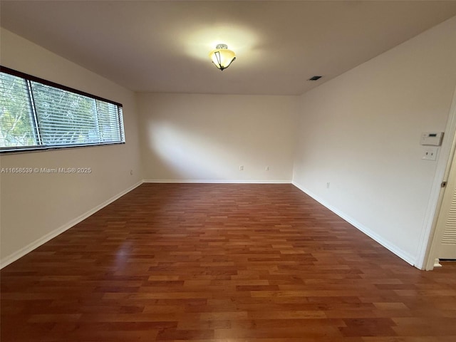 spare room featuring dark hardwood / wood-style floors