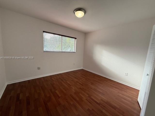 empty room featuring dark wood-type flooring