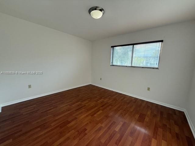 empty room featuring dark hardwood / wood-style floors