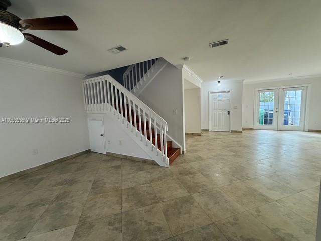 interior space featuring ceiling fan, ornamental molding, and french doors