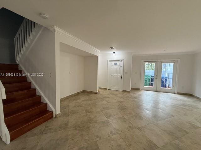 empty room with crown molding and french doors