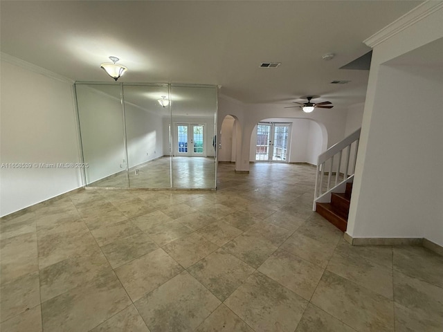 empty room featuring ceiling fan, french doors, and ornamental molding