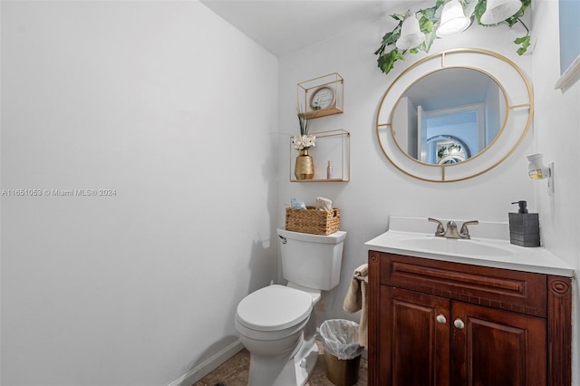 bathroom featuring toilet and vanity