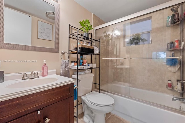 full bathroom with shower / bath combination with glass door, vanity, toilet, and tile patterned floors