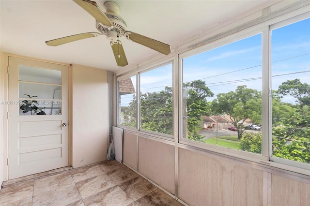 unfurnished sunroom featuring plenty of natural light and ceiling fan