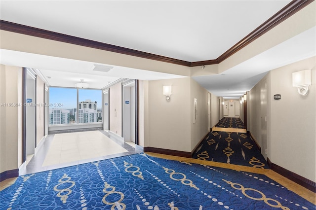 hallway featuring tile patterned flooring, ornamental molding, and elevator