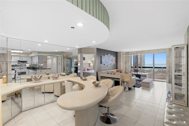 interior space featuring light tile patterned floors and white electric stove