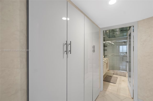 hall featuring light tile patterned floors