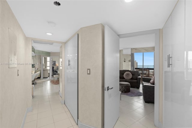 hallway featuring light tile patterned floors