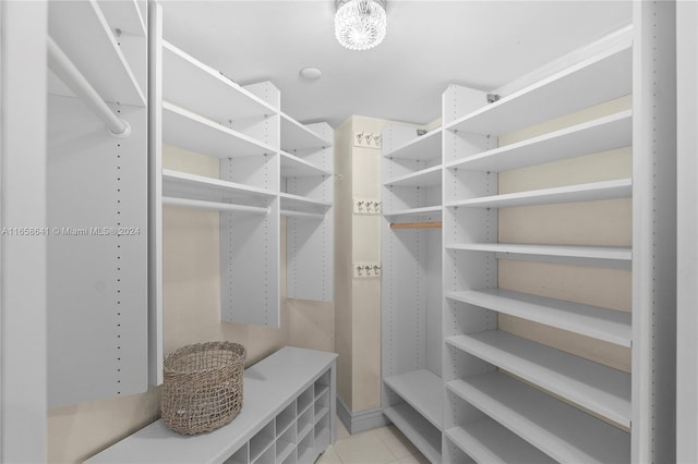 walk in closet with light tile patterned floors