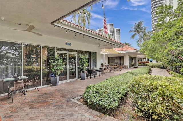 exterior space featuring ceiling fan