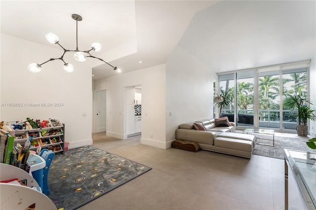 living room with vaulted ceiling and a notable chandelier