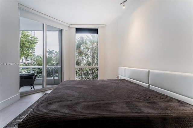 unfurnished bedroom featuring floor to ceiling windows