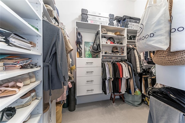 walk in closet featuring light carpet