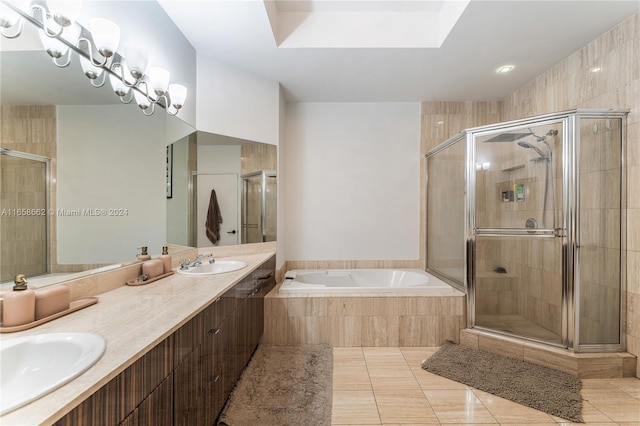 bathroom with tile patterned floors, a skylight, independent shower and bath, and vanity