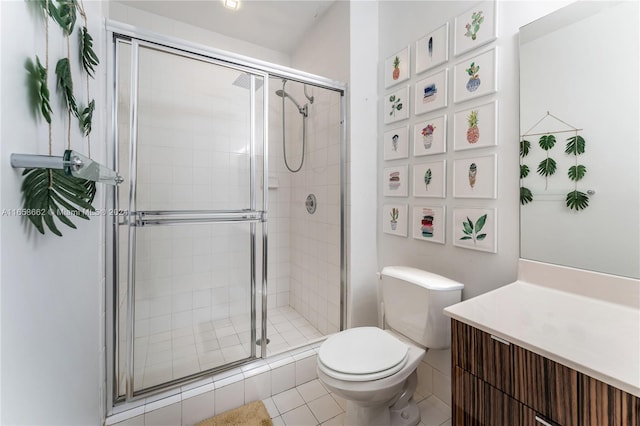 bathroom with tile patterned floors, a shower with door, vanity, and toilet