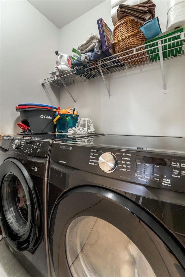 clothes washing area with washing machine and clothes dryer