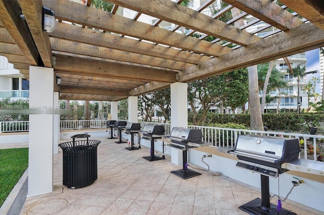 view of patio / terrace featuring a pergola, area for grilling, and exterior kitchen