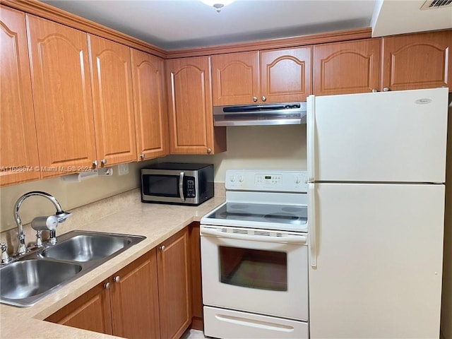 kitchen featuring white appliances and sink