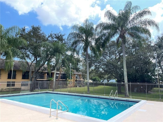 view of pool with a yard