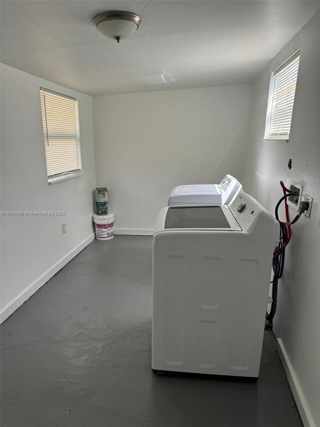 clothes washing area with washing machine and dryer