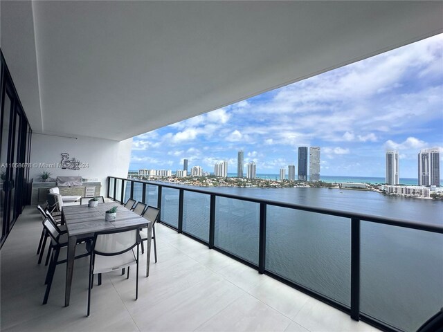 balcony featuring a view of city and a water view