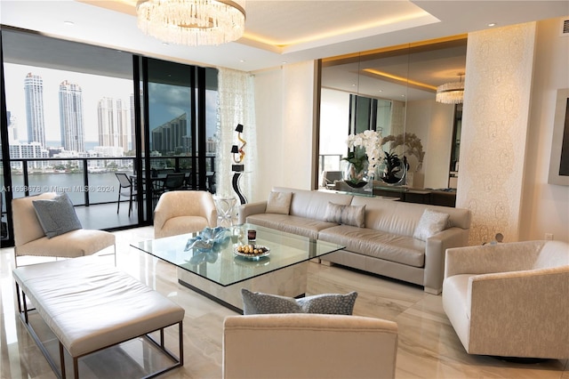 living room with an inviting chandelier, a raised ceiling, a view of city, and expansive windows