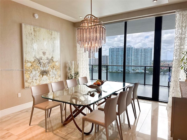 dining space with a city view, an inviting chandelier, and baseboards