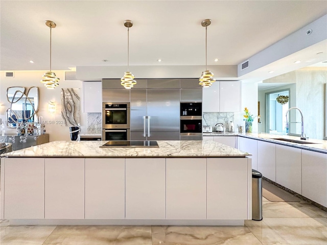 kitchen featuring a large island, stainless steel double oven, white cabinets, modern cabinets, and a sink