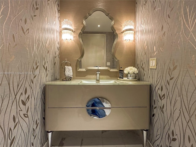 bathroom with wallpapered walls and vanity