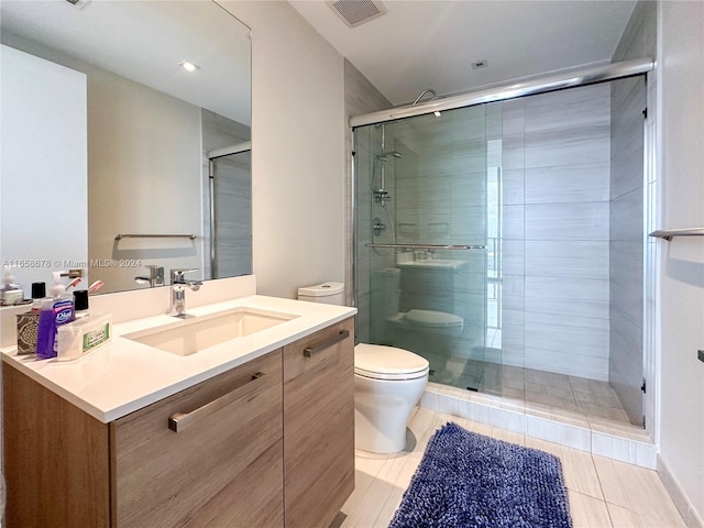 bathroom with visible vents, a shower stall, toilet, and vanity