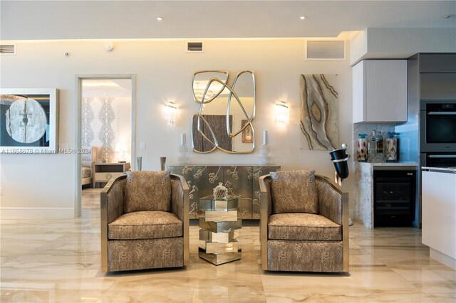 living area with visible vents and marble finish floor