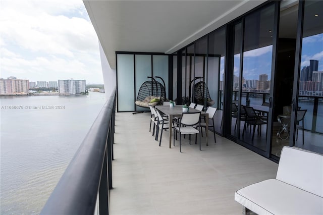 balcony featuring a water view and a city view