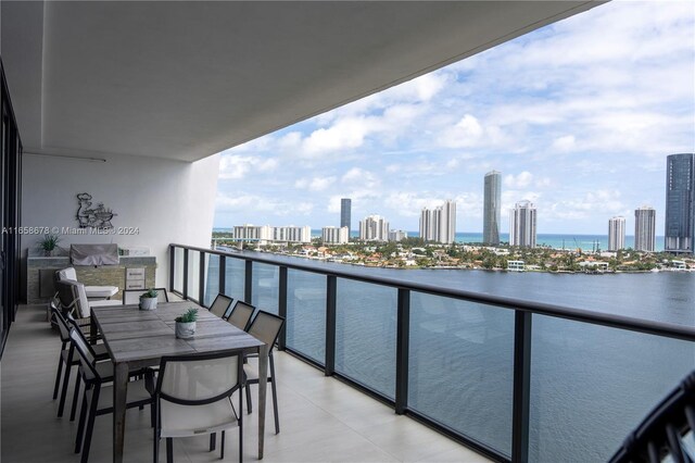 balcony featuring a city view and a water view