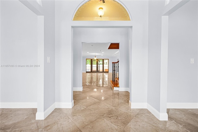 hall featuring marble finish floor and baseboards