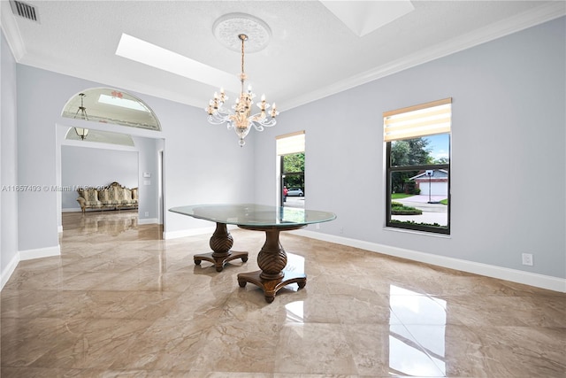 dining area featuring a notable chandelier, a textured ceiling, and ornamental molding