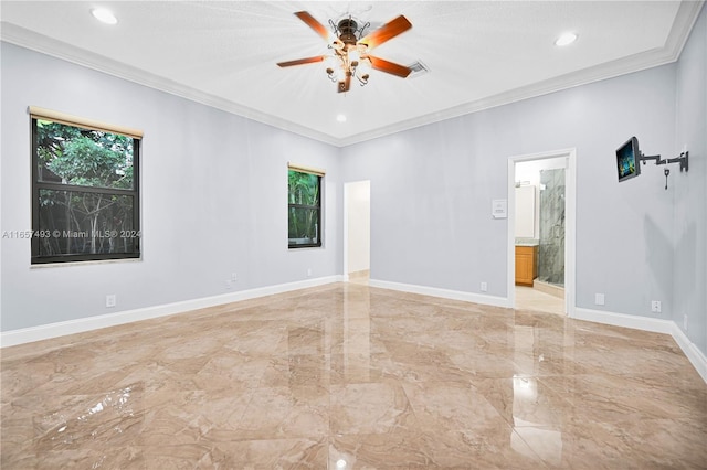 spare room with marble finish floor, visible vents, a ceiling fan, ornamental molding, and baseboards